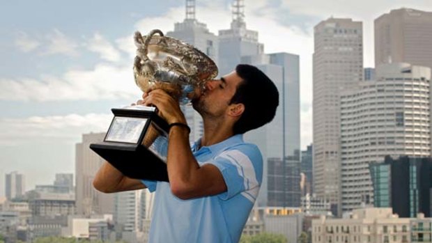 Sweet success ... Novak Djokovic shows off his Open trophy.