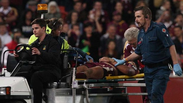 Long term effects? ... Steve Price of the Maroons is taken from the field injured during game three of the 2009 State of Origin series.
