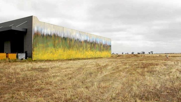 Monumental effort: Ash Keating's West Park work along the side of a concrete warehouse is 50 metres long and two storeys high.