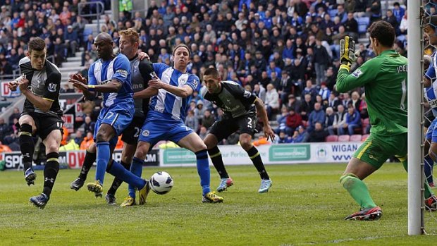 Wigan Athletic's Emmerson Boyce (second left) deflects the ball past his goalkeeper Joel Robles (right) to concede an own goal during the match against Tottenham Hotspur on Saturday.