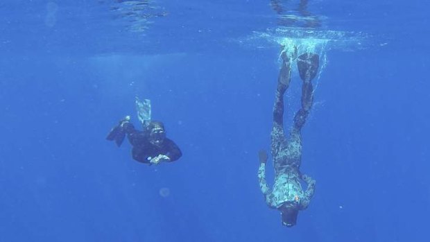 Able Seaman Clearance Divers Matthew Johnston and Michael Arnold embarked on Australian Defence Vessel Ocean Shield, scan the water for debris in the search zone in the southern Indian Ocean for the missing Malaysian Airlines flight MH370.