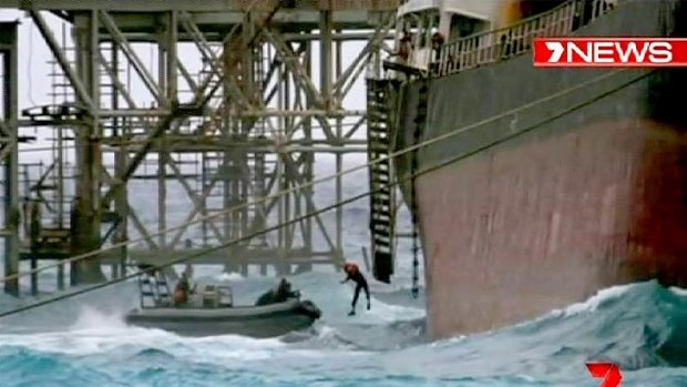 A crewman jumps into the sea as the MV Tycoon breaks up.