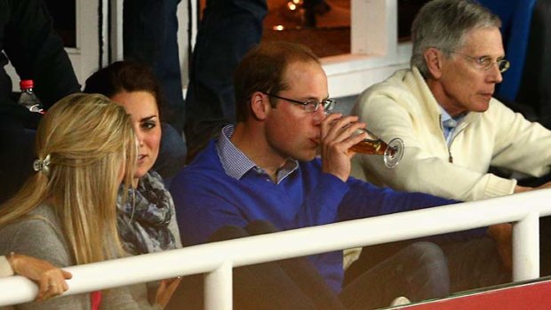 Off duty: Prince William enjoys a beer while sitting with Catherine to watch the match between the Waratahs and the Bulls at Allianz Stadium.