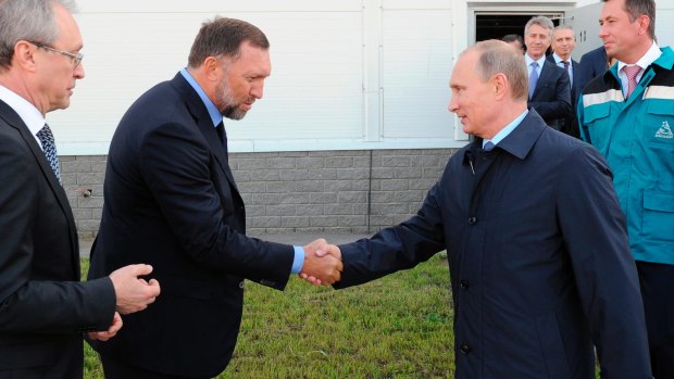 Russian President Vladimir Putin, right, shakes hands with Russian metals magnate Oleg Deripaska in Kstovo, in Russia's Nizhny Novgorod region. 