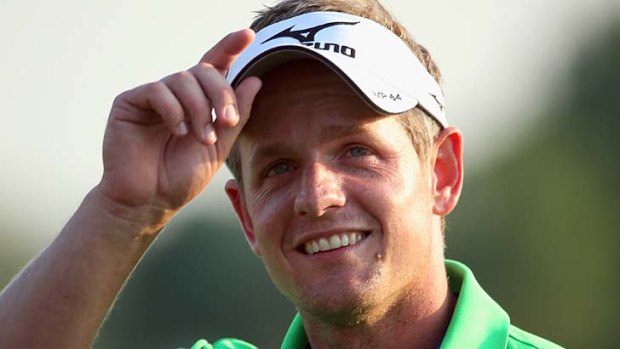 Luke Donald of England waves to the crowd on the 18th green during the first round of the DP World Tour Championship on the Earth Course at Jumeirah Golf Estates in Dubai, United Arab Emirates.