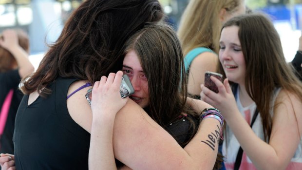 A fan waits for One Direction to arrive at Adelaide airport.