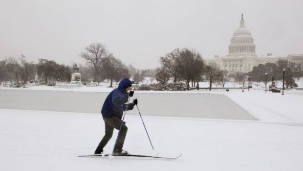 More snow than Sochi ... A lone cross country skier braves the cold and snow to ski near the US Capitol Building in Washington.