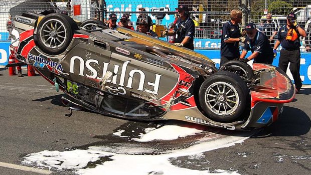 The #33 Fujitsu Racing GRM Holden car lays on the track after Ricky Taylor of the USA had a rollover.
