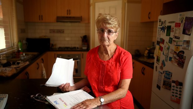 Elaine Gray, 75, with the final notice she received from Spotless' debt collectors for a bill that she had already paid.