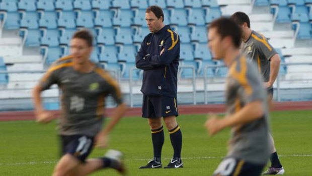 ''I'm not the kind of guy who gambles'' ... coach Holger Osieck watches the Socceroos train in Doha. He says he will field his best side against India.