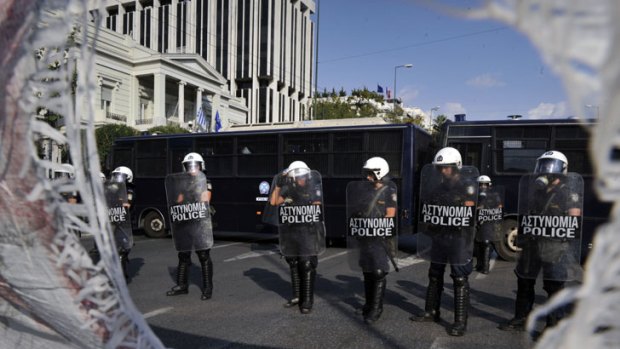 Stand-off ... police stand guard during a student demonstration opposing educational reform and austerity measures in Athens.
