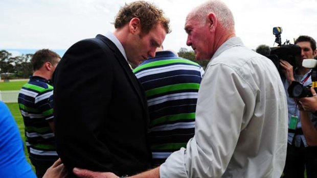 Time of need ...  Joel Monaghan is comforted by his father at yesterday's news conference to announce his resignation from the Raiders.