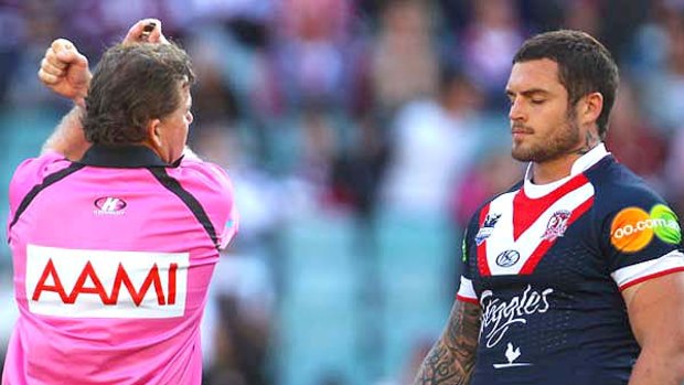 Referee Tony Archer places Daniel Conn of the Roosters on report.