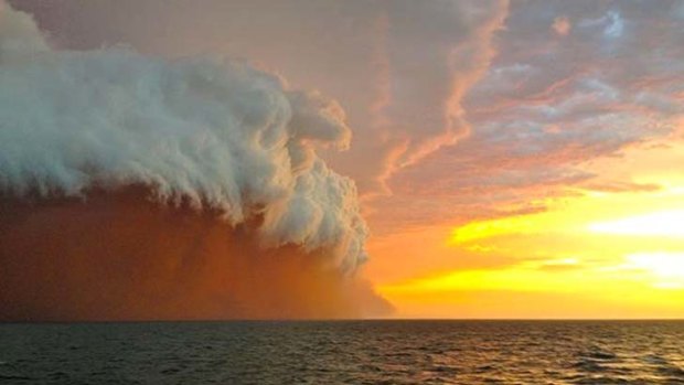 A wall of dust and water whipped up by cyclone Narelle as seen in this photo. taken by Brett Martin 25 nautical miles north-west of Onslow, Western Australia.