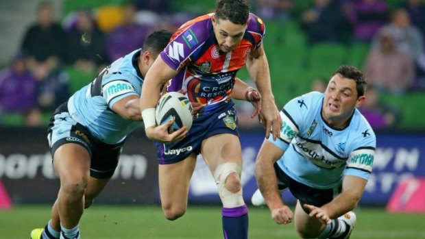 Breaking the line: Billy Slater makes a bust for the Storm.