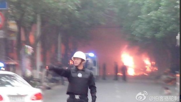 Fires in the street after the explosions at a market in Urumqi. (Via Weibo)