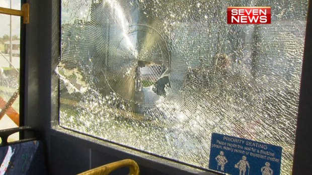 Police breaking up an out-of-control party in Acacia Ridge overnight Saturday were forced to drag two injured colleagues into a Brisbane council bus after they were attacked with bricks.