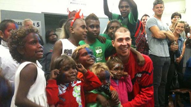 Dee-lighted: Children from Yuendumu join Jim Stynes in the Melbourne rooms after last week's matches in Adelaide.