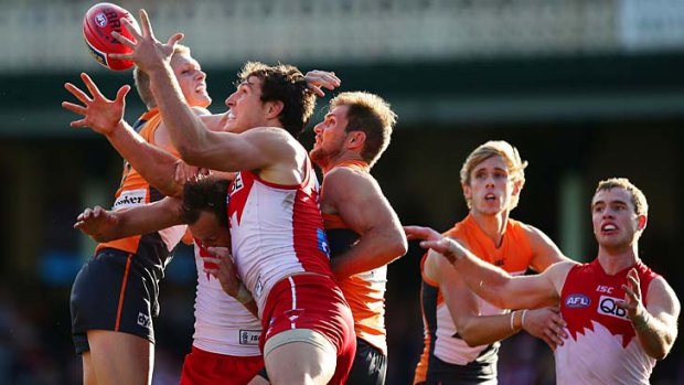 Tall order: Sydney's Kurt Tippett attempts to mark in a nest of players.