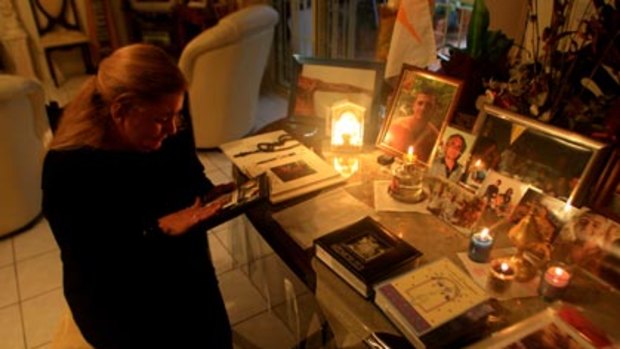 A living nightmare...Frederika Bromwich at a table covered in tributes to her son Anthony, who was bashed to death during a  brawl between two bikie gangs.