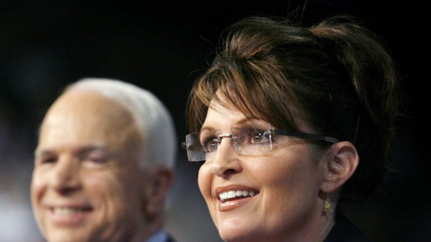 US Republican presidential candidate Senator John McCain looks on as his vice presidential running mate Alaska Governor Sarah Palin speaks at a campaign event in Dayton, Ohio,