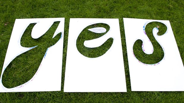 Signs at yesterday's rally in support of a carbon tax in Brisbane.