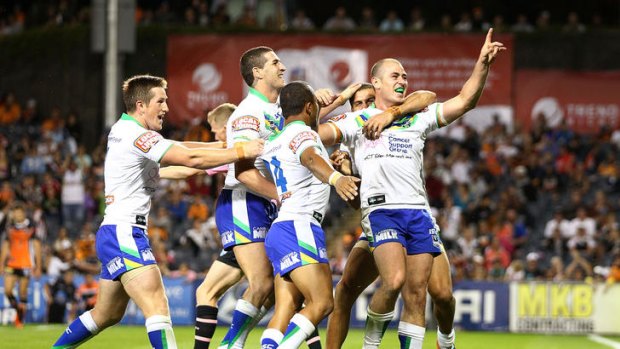 Terry Campese of the Raiders celebrates his try with teammates during the round four NRL match against the Wests Tigers.