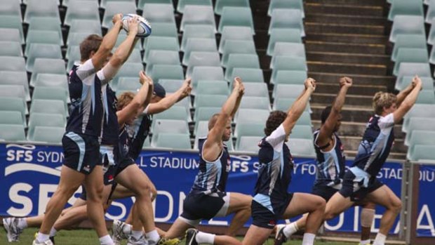 At a stretch ... members of the Waratahs squad train at the Sydney Football Stadium yesterday. They are not expecting an open game against the Reds at ANZ Stadium on Saturday.