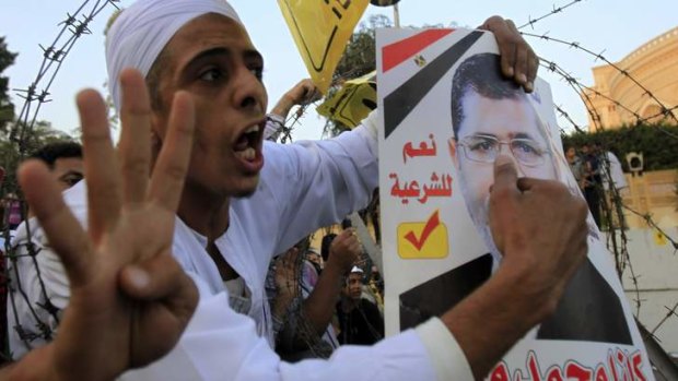 Keeping up the pressure: Supporters of the Muslim Brotherhood and ousted Egyptian President Mohamed Mursi shout slogans against the military.