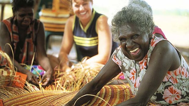 Indigenous women teach weaving.