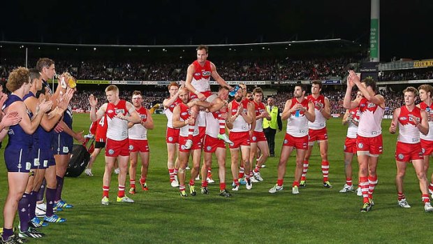 Glittering career: Jude Bolton gets carried off by Jarrad Mcveigh (left) and Ryan O'Keefe.