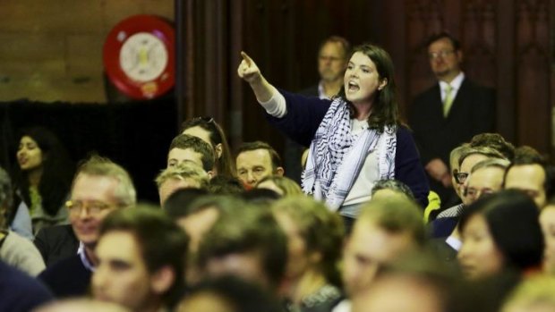 Widespread opposition ... a student protests against fee deregulation at the meeting on Monday night.