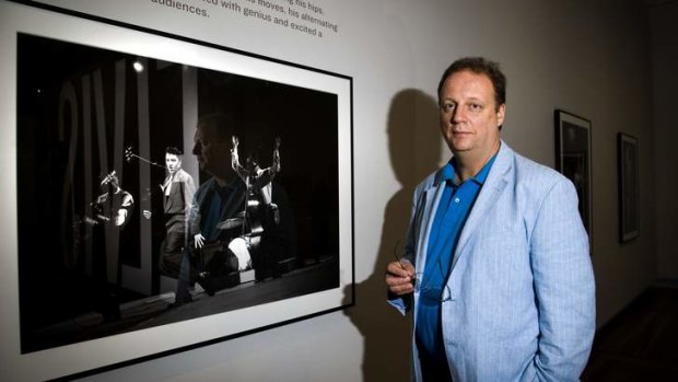 BEFORE THE KING WAS CROWNED: Smithsonian National Portrait Gallery researcher Warren Perry with one of the portraits from Elvis at 21.