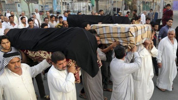 Friends and family  of victims of a suicide bombing  carry coffins during a funeral in the Shula neighborhood of Baghdad.