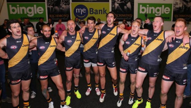 Richmond players belt out the club song as they celebrate victory over Essendon on Friday.