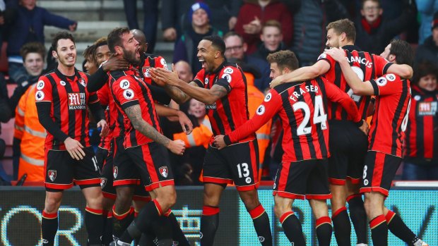 Thriller: Bournemouth celebrate their incredible win over Liverpool.