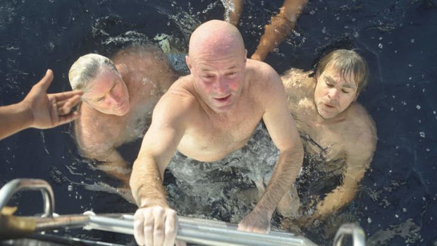 Saved: Brett Archibald climbs to safety watched by Simon Carlin (left) and Colin Chenu (right).