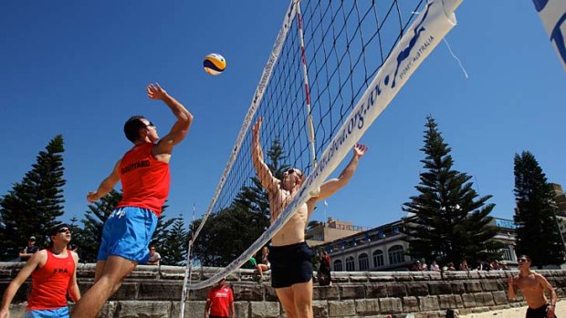 Firefighters compete during the beach volleyball event at Coogee Beach.