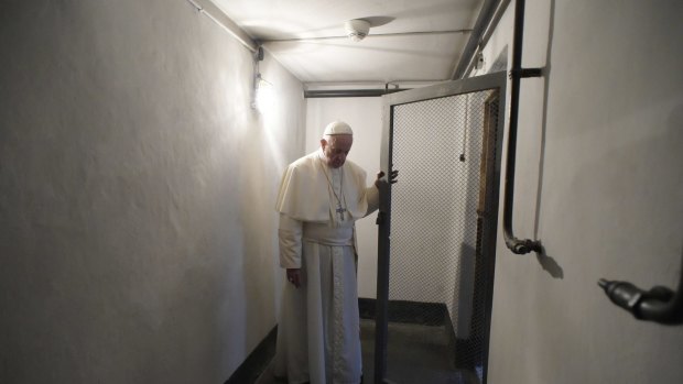 Pope Francis visits the Auschwitz prison cell of Catholic saint Maximilian Kolbe.