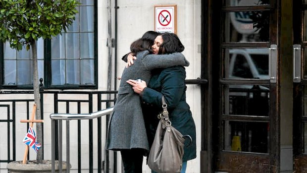 Two women hug on the steps of the King Edward VII hospital in central London.