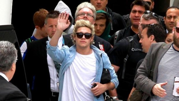 Niall Horan from One Direction waves to fans.