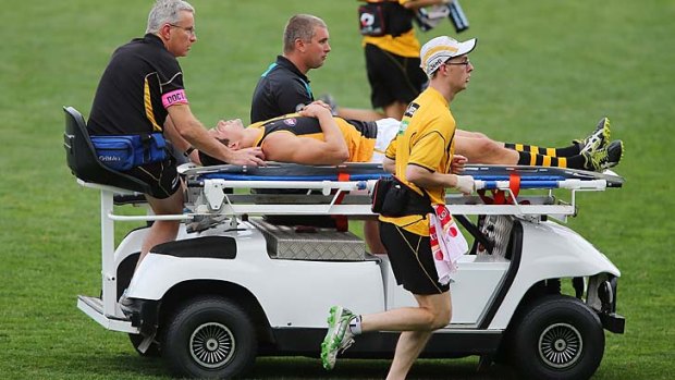Chris Knights is stretchered from the field during the match against Port Adelaide.