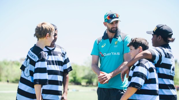 Australian Cricketer Nathan Lyon talks to Alfred Deakin students Harry Broadhead, Yashwanth Sridhar, Aidan Mara and Rahi Dean during the Milo T20 Blast Schools Cup at Deakin Oval.