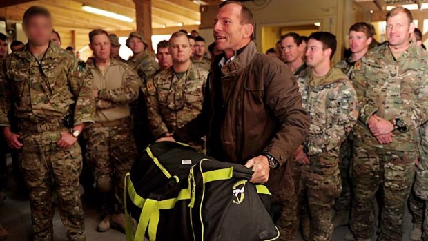 Tony Abbott with troops serving in Tarin Kowt, where the Opposition Leader stopped en route to London.