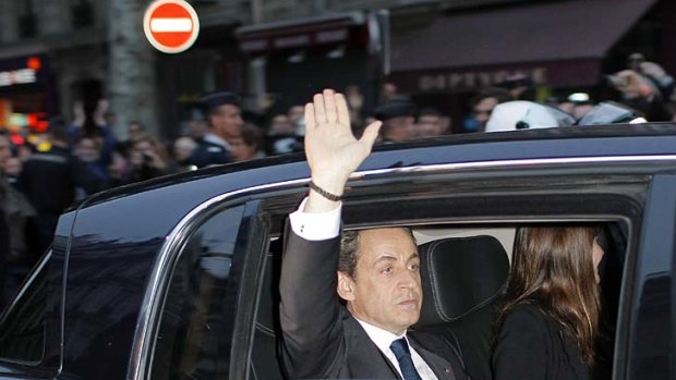 Waving goodbye ... outgoing French President Nicolas Sarkozy.