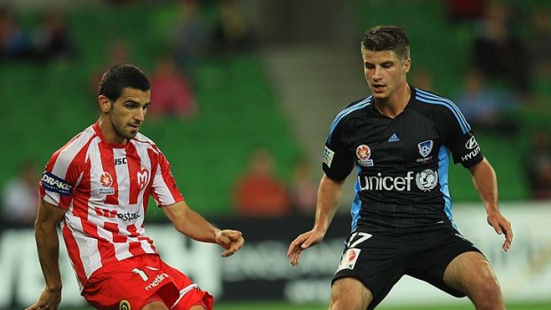 Melbourne Heart's Aziz Behich tries to get past Terry Antonis of Sydney during the round 24 game on the weekend.
