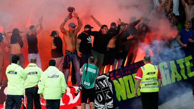 Western Sydney Wanderers fans let off flares during the round 12 A-League match against Melbourne Victory at AAMI Park.