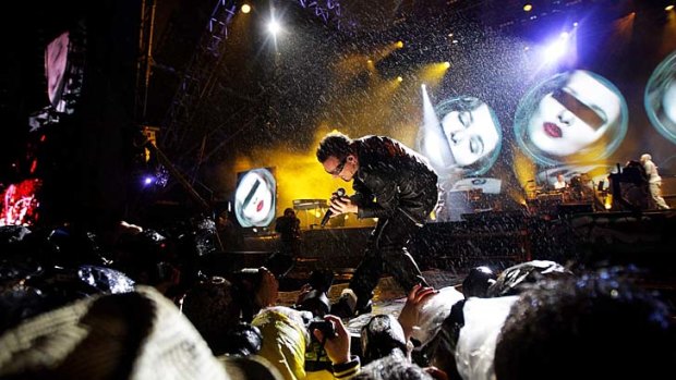 Bono of U2 serenades the Glastonbury crowd.