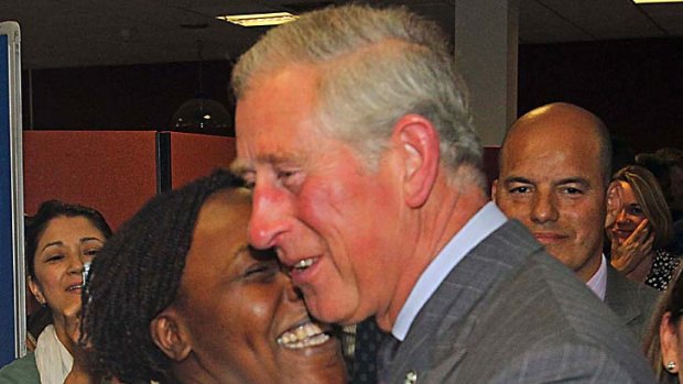 Hug for a prince ... Charles gets a cuddle at a leisure centre in Tottenham.