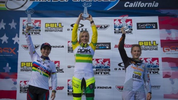 Caroline Buchanan hoists the trophy after sealing the BMX World Cup series title in the final round in California.